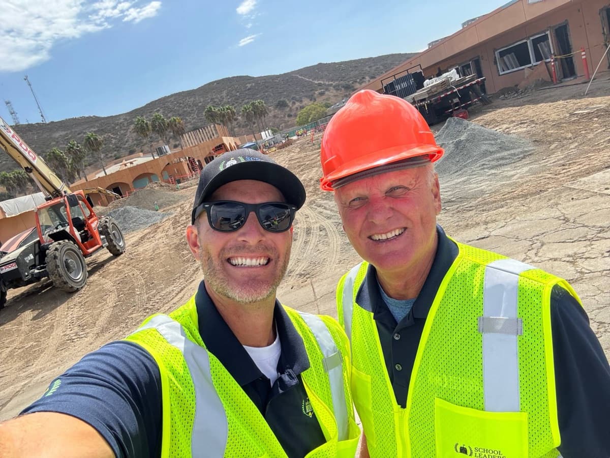 Jay on a construction site with a colleague