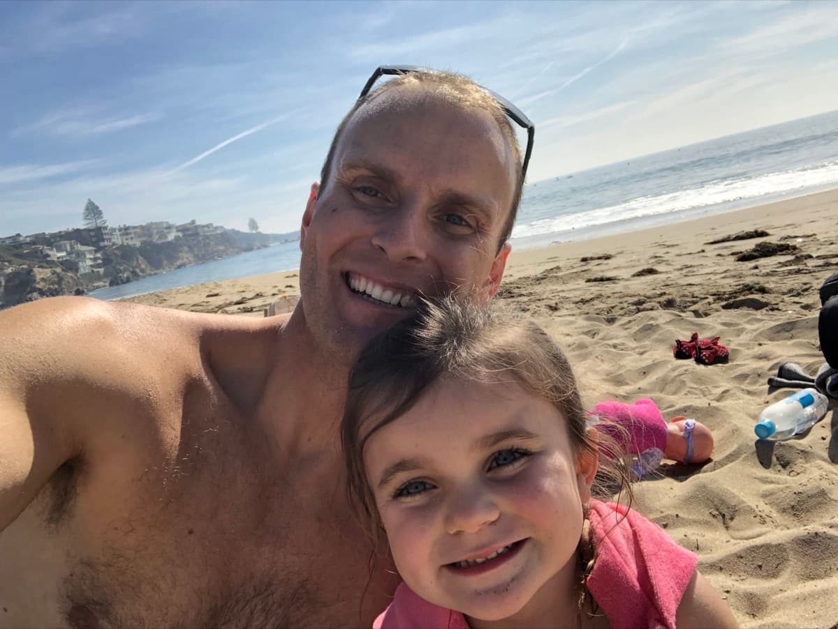 Jay at the beach with his daughter