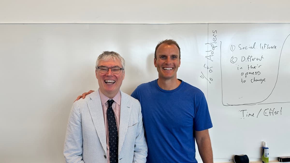 Jay with a professor at a whiteboard
