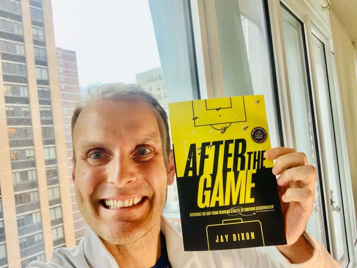 Jay holding a copy of After the Game